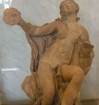 Truth Unveiled by Time, a reddish-brown marble statue of a nude woman with her head tilted back and her left hand raised holding a shell-like object.
