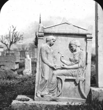 Grave Stele of Hegeso showing two women in classical drapery, one seated and holding a small object while the other stands beside her.