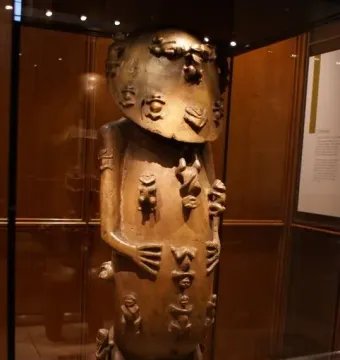 Carved wooden figure of A\'a covered with small raised figures