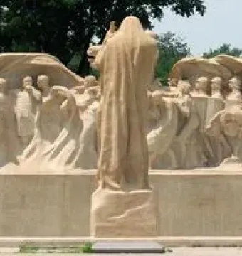 Lorado Taft\'s Fountain of Time sculpture with a central robed figure overseeing a long procession of human figures.