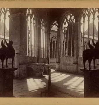 Stereoscopic view of the Pisa Griffin silhouetted on a pedestal inside a sunlit hall with tall arched windows.