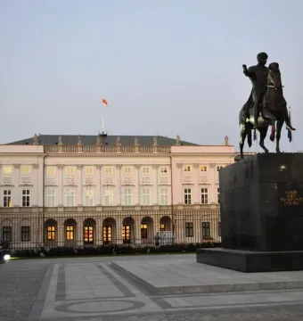 Prince Józef Poniatowski Monument with a bronze equestrian statue before a classical building in Warsaw