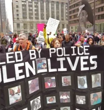 The Picasso sculpture rises above a crowd of protesters in downtown Chicago.