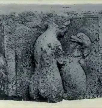 Worn relief sculpture from the Pilier d\'Yzeures-sur-Creuse showing several carved human figures in horizontal arrangement.