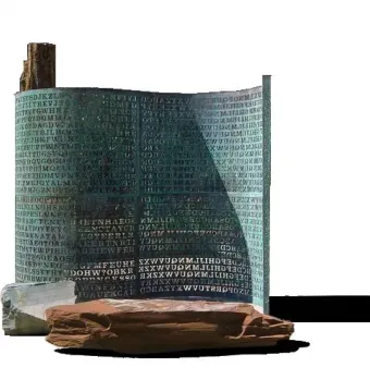 Kryptos sculpture with a curved patinated metal surface covered in etched letters and numbers, standing on rocks.
