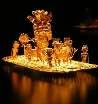 Muisca Raft with a central figure and surrounding oarsmen in a gold-colored sculptural model