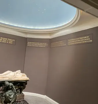 Shelley Memorial with a reclining marble figure above a seated figure in a decorated interior