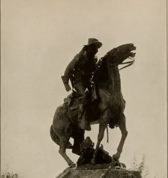 Buckey O\'Neill Monument showing an equestrian bronze statue of a man in a wide-brimmed hat on a rearing horse atop a stone pedestal.
