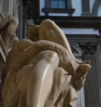 Close-up of Michelangelo’s Evening showing the reclining marble figure’s bare legs and foot.