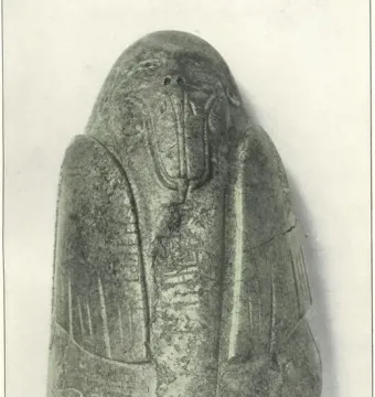 Tuxtla Statuette with an elongated carved head, protruding mouth, and incised decorative patterns