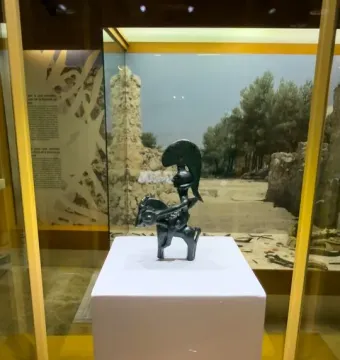 Warrior of Moixent figurine of a horseman with a crested helmet and round shield in a display case.