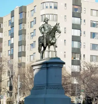 Bronze equestrian statue of Winfield Scott on a tall stone pedestal marked \