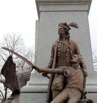 Tadeusz Kościuszko Monument showing a bronze standing figure with a feathered hat, a kneeling soldier, and an eagle on a stone pedestal.