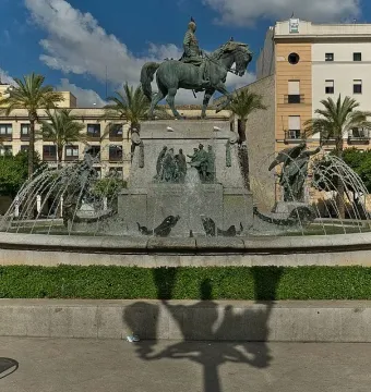 The Monument to Primo de Rivera, a bronze equestrian statue on a stone base within a circular fountain.
