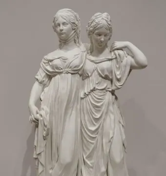 Princesses Monument showing two white classical women in flowing gowns standing together on a base.