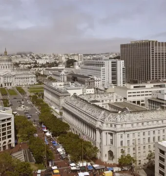 Pioneer Monument at a San Francisco street intersection, with a domed building in the background.