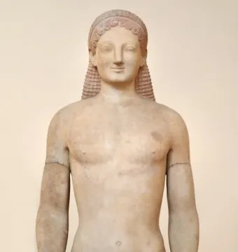Kouros marble statue of a standing nude male figure with braided hair, an archaic smile, and a missing left forearm.