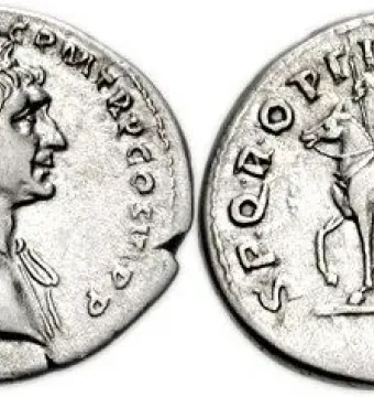 Reverse of a Roman coin showing Trajan’s equestrian statue with a mounted figure holding a spear.