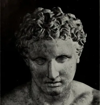 Head and upper torso of the Ludovisi Ares marble statue with curly hair and a solemn expression against a dark background.