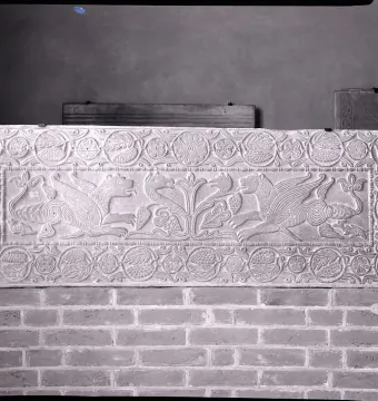 The Plutei of Theodota stone relief with two winged beasts facing a central foliage motif and a patterned border.