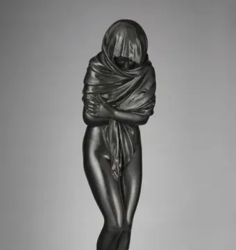 Winter, a dark bronze figure in a heavy draped robe with arms crossed over the chest.