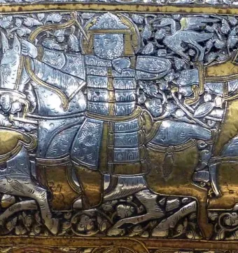 Battle scene panel from the Baptistery of Saint Louis showing armored horsemen, bows, spears, and scrolling foliage.
