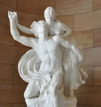 Mercury and Psyche sculpture showing a man with one arm raised and a seated woman holding hands on a rocky base.