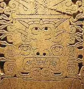 Detailed carving on the Raimondi Stela showing a stylized face with swirling geometric patterns.