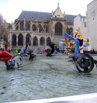 Stravinsky Fountain with colorful abstract sculptures in a shallow basin before the Centre Pompidou in Paris.