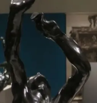 The Prodigal Son bronze sculpture showing a male figure from the waist up with arms raised above his head.