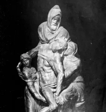 The Deposition sculpture showing a hooded figure supporting the body of Christ, with two draped figures assisting on either side.