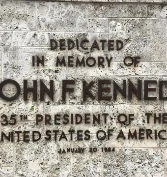 Raised lettering on the Torch of Friendship dedication plaque honoring John F. Kennedy.