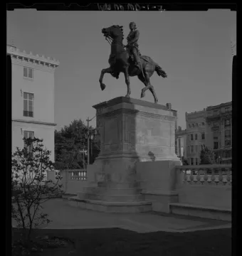 Lafayette Monument with an equestrian statue on a stone pedestal in a paved public space.