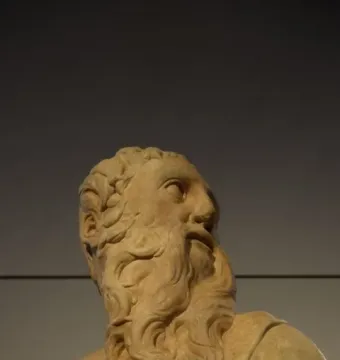 Marble sculpture of the Sacrifice of Isaac showing an older bearded man looking upward.