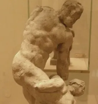 Michelangelo\'s Two Wrestlers, an earthen-toned sculpture of two muscular male figures locked in a wrestling struggle.