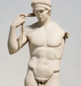 Farnese Diadumenos, a white marble nude male statue adjusting a headband with his right hand and missing his left arm.