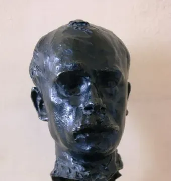 Bronze bust of Octave Mirbeau on a light marble base
