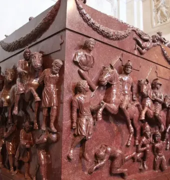 Red porphyry Sarcophagus of Helena carved with mounted soldiers, figures, and garland decoration.