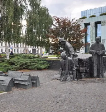 Warsaw Uprising Monument with bronze figures and collapsed building forms on a cobblestone plaza