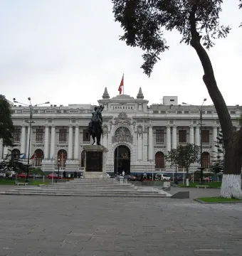 The Equestrian Statue of Simón Bolívar on a tall stone pedestal in front of the Congress of Peru building.