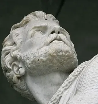 Close-up of the Winkelried Memorial showing a marble head and upper torso of a bearded man with armor on one shoulder.