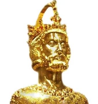Golden bust of Charlemagne with a crown, beard, and ornate jewel-like decoration.