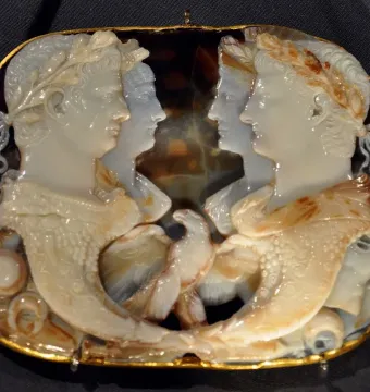 Gemma Claudia cameo with four profile figures in a gold-colored frame