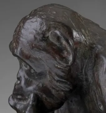 Close-up of the Monkey with a Skull bronze sculpture showing a contemplative primate in profile.
