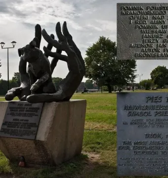 Monument to Dog Jock, a bronze sculpture of a dog held in two open hands on a stone base.