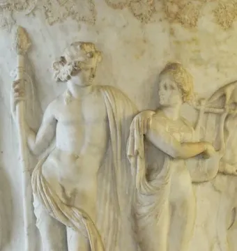 Marble relief from the Borghese Vase showing a nude male figure with a staff beside a draped woman playing a lyre.