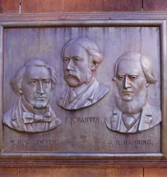 Bronze relief plaque on the Maitland Brown Memorial showing busts of W. H. Goldwyer, F. K. Panter, and J. R. Harding.