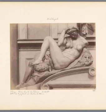 Michelangelo’s Night, a reclining nude marble figure with an owl and mask on the base.