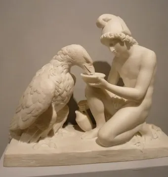 Ganymede with Jupiter\'s Eagle marble sculpture of a kneeling young man offering a dish to an eagle.