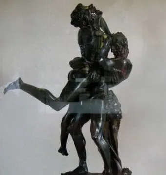 Hercules and Antaeus bronze sculpture showing two muscular figures in a struggle on a marble pedestal.